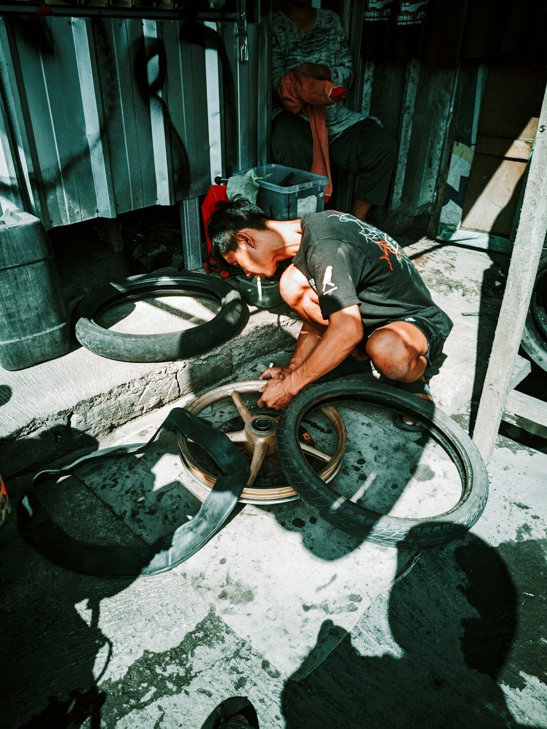 man repairing old bicycle